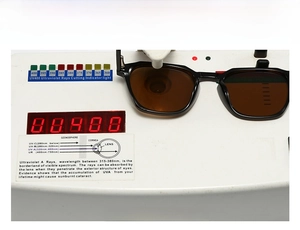 Detailed UV400 test showing brown polarized lenses blocking ultraviolet rays on device