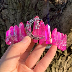 Close-up of handmade pink crystal crown with hollow metal moon and stars detailing