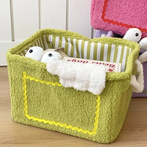 Green plush monster storage basket with yellow wave pattern and durable woven handles