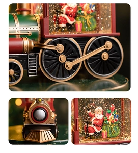 Macro shot of detailed train wheels and Santa snow globe inside Christmas music box