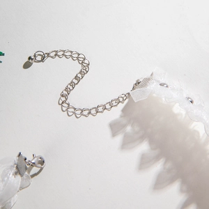 Close-up of white lace choker with silver adjustable extension chain and lobster clasp