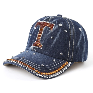 Washed dark blue denim baseball cap with rhinestone letter T and metallic studs