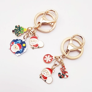 Detail of Christmas keychains with Santa Claus, Xmas tree and candy cane enamel charms