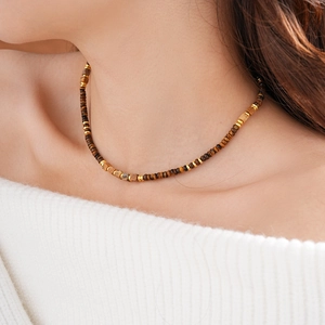 Detailed close-up of a vintage square tiger eye stone necklace with gold metallic beads
