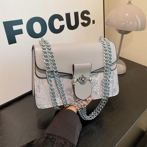 Elegant grey high-capacity chain shoulder bag with floral clasp and intricate patterned base