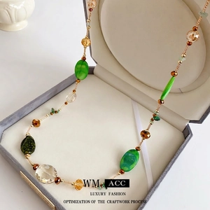 Bohemian beaded long necklace with green agate and champagne glass beads in a jewelry box