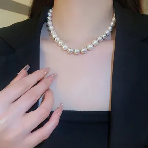 Elegant pearl and hammered silver bead necklace styled with a professional black blazer