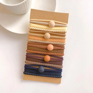 Detail of multi-textured elastic hair ties set with matte beads on display card
