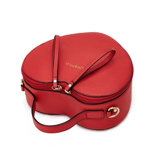 Detail of red heart-shaped handbag with Saffiano leather texture and gold hardware