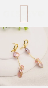 Detailed macro shot of long 18k gold plated tassel earrings with baroque pearls