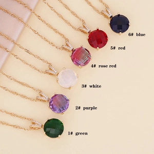 Close-up of glass pendants in six vibrant colors with gold twisted chains and crystals