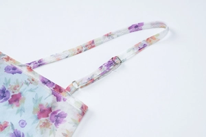 Detail of adjustable floral mesh straps with high-quality metal buckles on a slim dress
