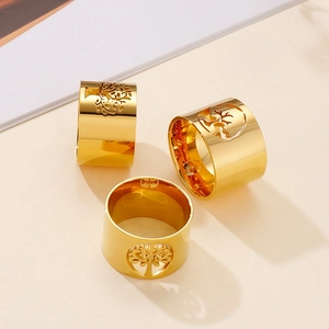 Polished gold titanium steel wide band ring featuring a hollow Tree of Life design