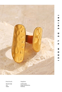 Detailed view of 18K gold plated ring with hammered texture on a textured stone base