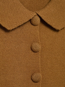 Macro view of brown knit cardigan texture with fabric covered buttons and collar detail