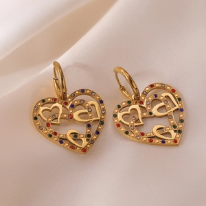 Gold plated stainless steel heart earrings with colorful zircon stones on silk background