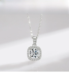 Macro shot of silver halo necklace featuring a round zircon and micro-paved square border