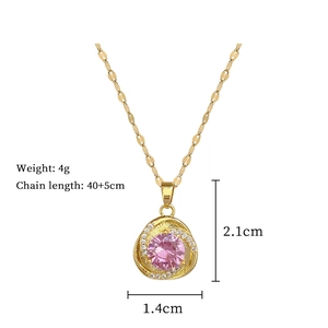 Macro view of gold-plated necklace with a pink gemstone and product measurements