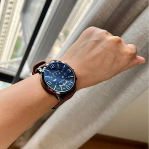 Classic blue dial watch with brown leather strap and large numeric markers for unisex wear