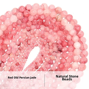Macro view of red Persian jade beads in various sizes with natural marble texture