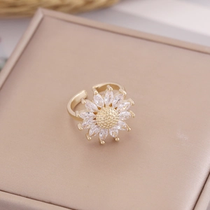 Macro shot of 18K gold sunflower ring featuring marquise-cut zircon petals and texture