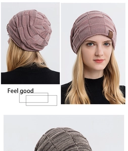 Detailed view of chunky knit beanies with plaid pattern and square leather logo patch