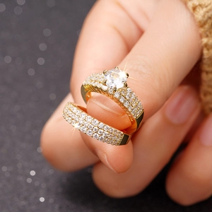 Macro shot of two-piece bridal ring set featuring a large round zircon and gold plating