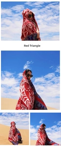 Detail of red oversized shawl with white and blue geometric triangles worn in the desert