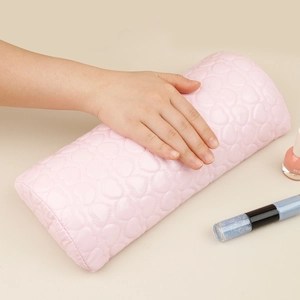 Detail of pink PU leather nail arm rest with heart quilting and manicure bottle