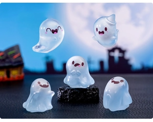 Close-up of translucent blue glowing ghost figurines for Halloween micro landscape