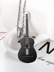Detail of a black guitar pendant necklace on a white mug with silver metal chain links