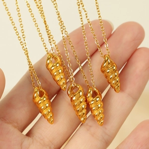 Elegant gold spiral conch pendant necklace set with minimalist layered metal chains