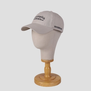Grey cotton baseball cap with black 'accomplish' embroidery on a display mannequin head