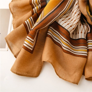 Macro detail of geometric horse carriage scarf showing soft linen-touch woven texture