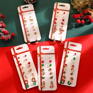 Christmas earrings set featuring Santa, reindeer, and snowflakes on a holiday card