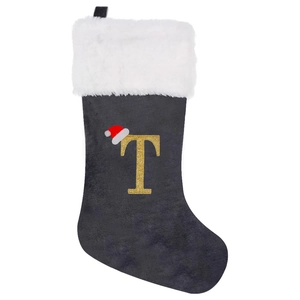 Detail of grey velvet Christmas stocking with golden sequin letter T and fur trim