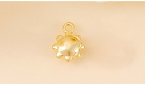 Macro shot of sun-shaped golden metal charms for DIY jewelry making and necklaces