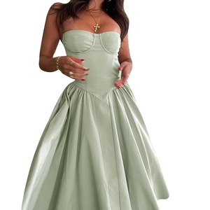 Close-up of a light green satin pleated dress featuring a fitted bodice and corset style