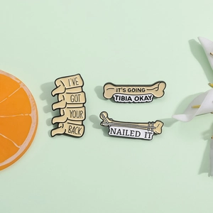Three medical bone enamel pins with funny slogans on a minimalist light green background
