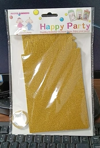 Detail view of 12-month baby photo banner with gold glitter cardstock for party decor