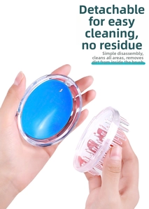 Detail view of the detachable blue silicone head massage brush for easy cleaning