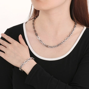 Detail view of 7mm silver square link stainless steel necklace and bracelet on model