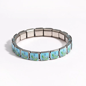 Detail of stainless steel modular bracelet with light blue tulip floral pattern in silver