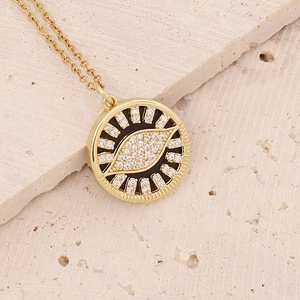 Detailed close-up of 18K gold-plated eye pendant necklace with micro-pave cubic zirconia