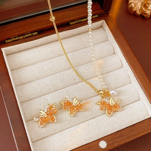 Exquisite golden unicorn jewelry set with orange zircon and pearls in a wooden box