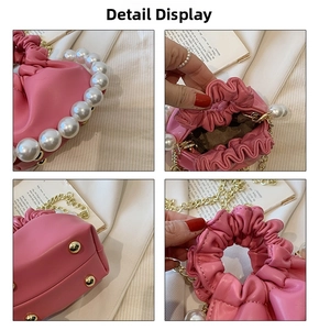 Detail of pink ruched princess bag with pearl handle and golden protective rivets