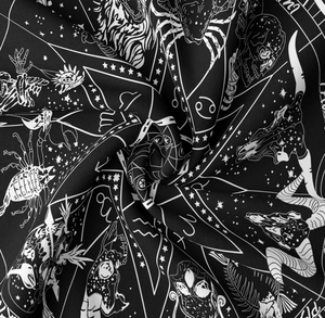 Detailed view of sun and moon tapestry fabric with celestial zodiac signs and symbols