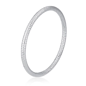 Detail of silver stainless steel bangle with diamond-cut texture and embossed pattern