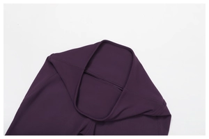 Detail view of high-waist yoga pants with reinforced stitching and matte purple fabric