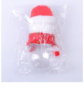 Close-up of a Christmas candy jar with a red plush Santa hat and knit scarf detail